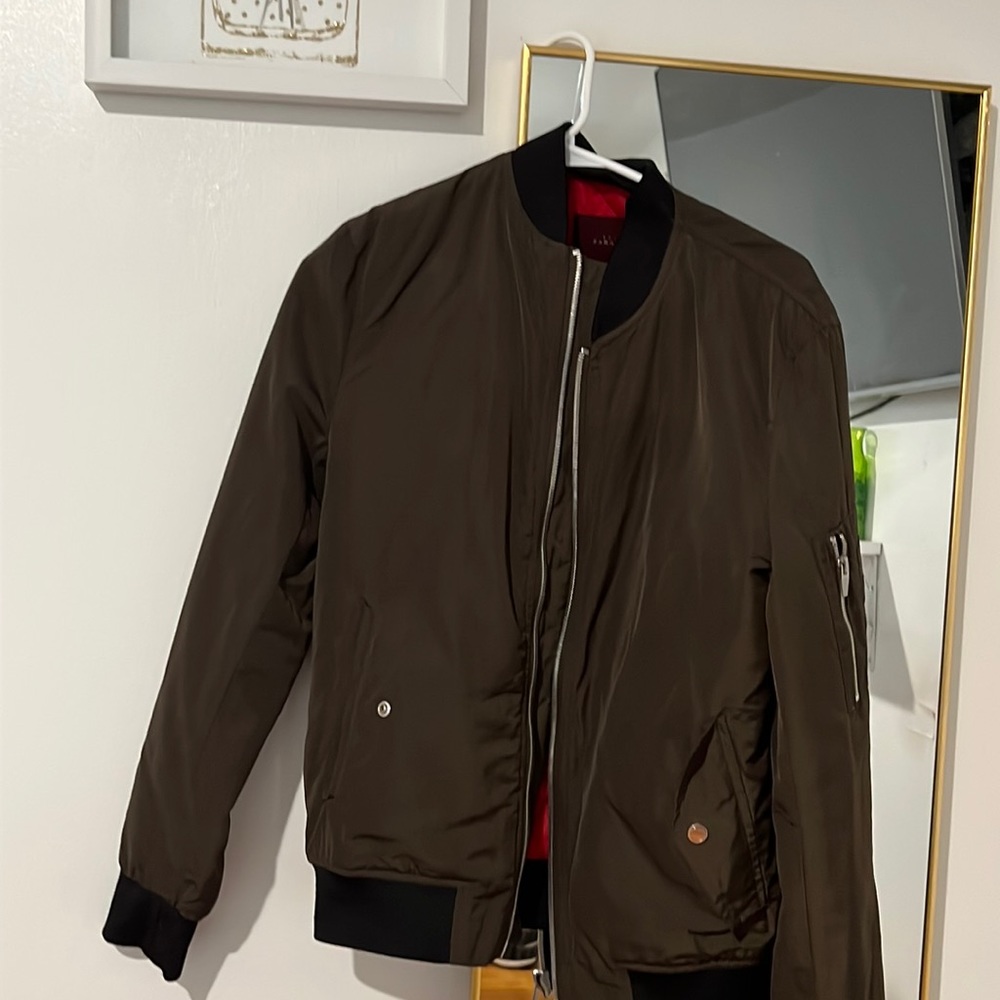 Used jacket in good condition color brown inside is red